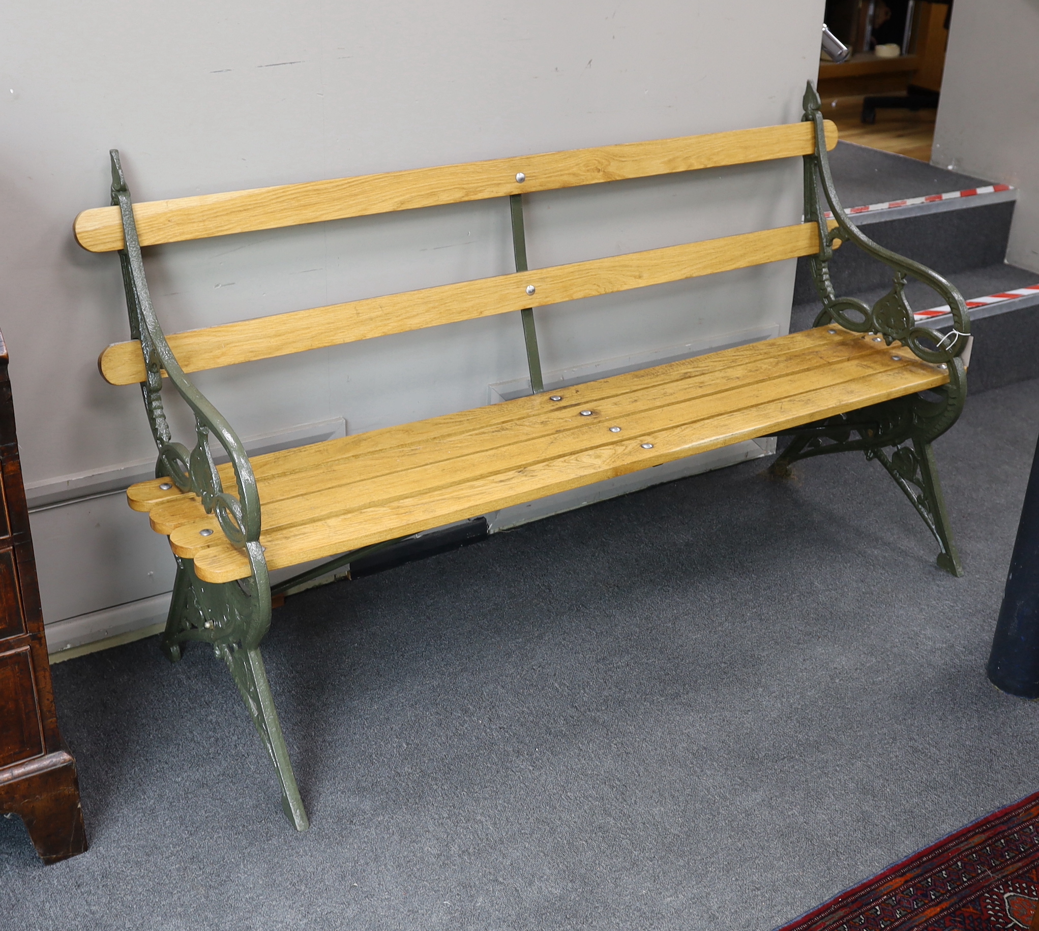 A Victorian Coalbrookdale 'lily pad' pattern cast iron garden bench restored with later ash slats, length 168cm, depth 54cm, height 93cm
